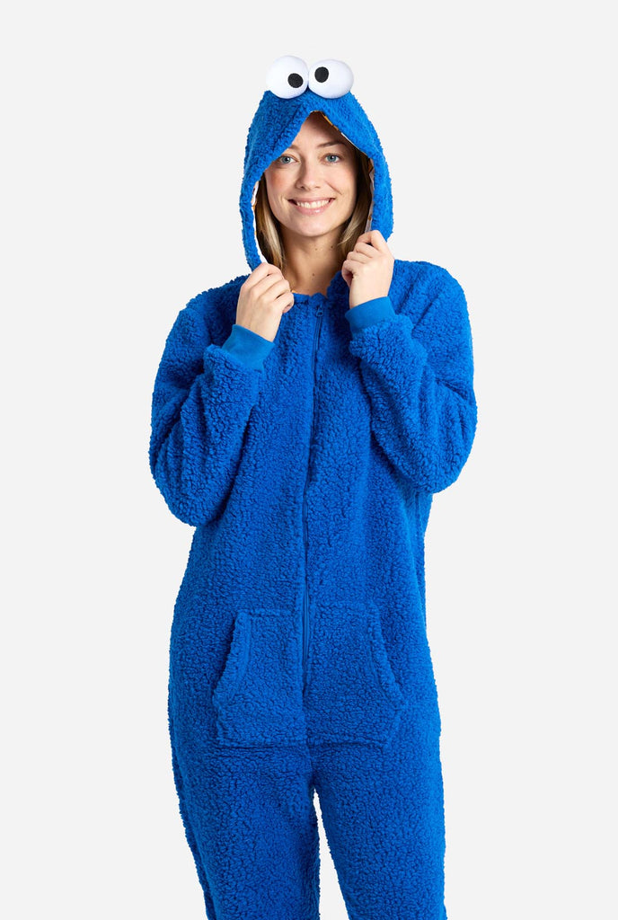 Woman wearing blue pluche Cookie Monster onesie for adults