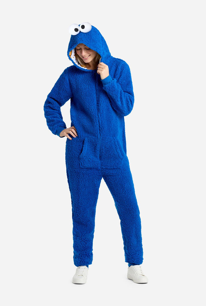 Woman wearing blue pluche Cookie Monster onesie for adults