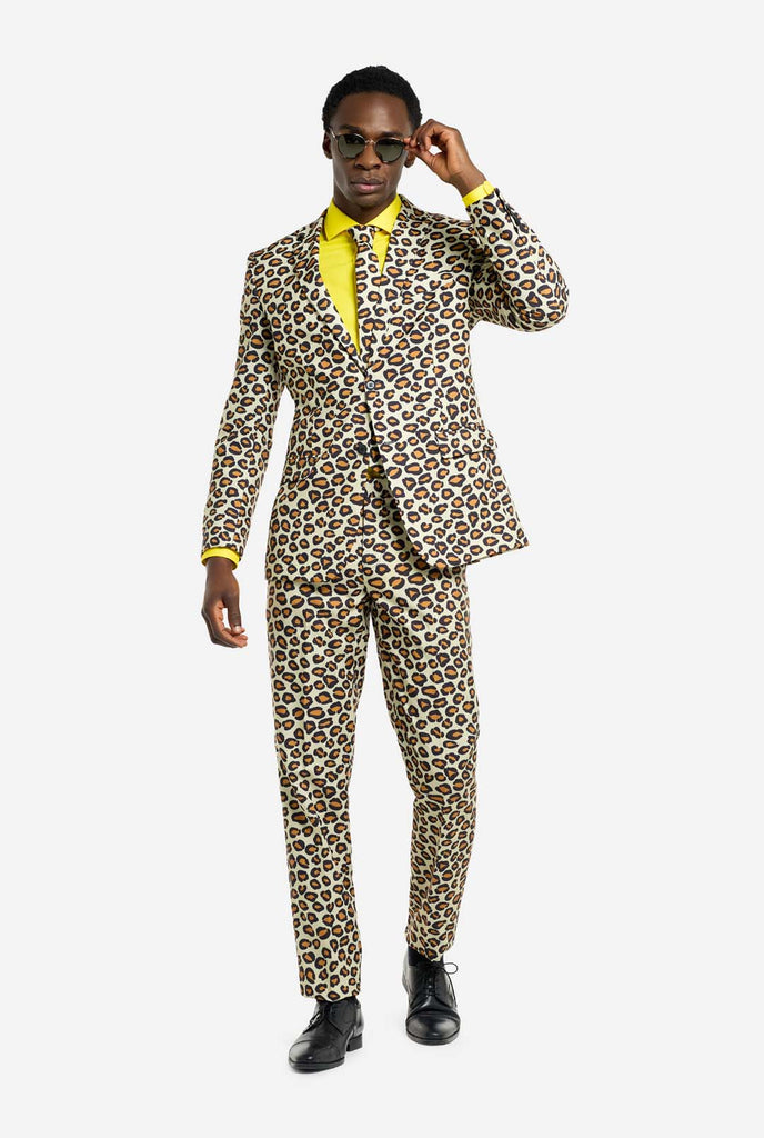 Image of a man wearing an OppoSuits The Jag men's suit with panther print and yellow men's shirt. Suit consist of pants, jacket and tie.