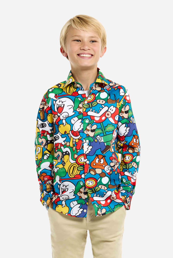 Image of teen wearing a Super Mario all over print shirt. Main color is blue, but there is also yellow, red and white.