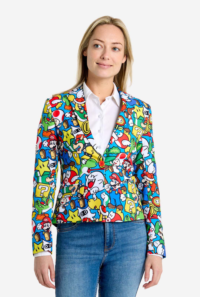 Woman wearing all-over print Super Mario blazer with iconic Super Mario characters. The base is light blue, but there is also yellow, red and white.