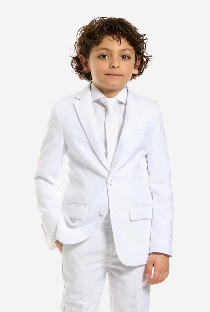 In this image, a kid is wearing a white suit for boys and white shirt. The consists of jacket, pants and clip-on tie.