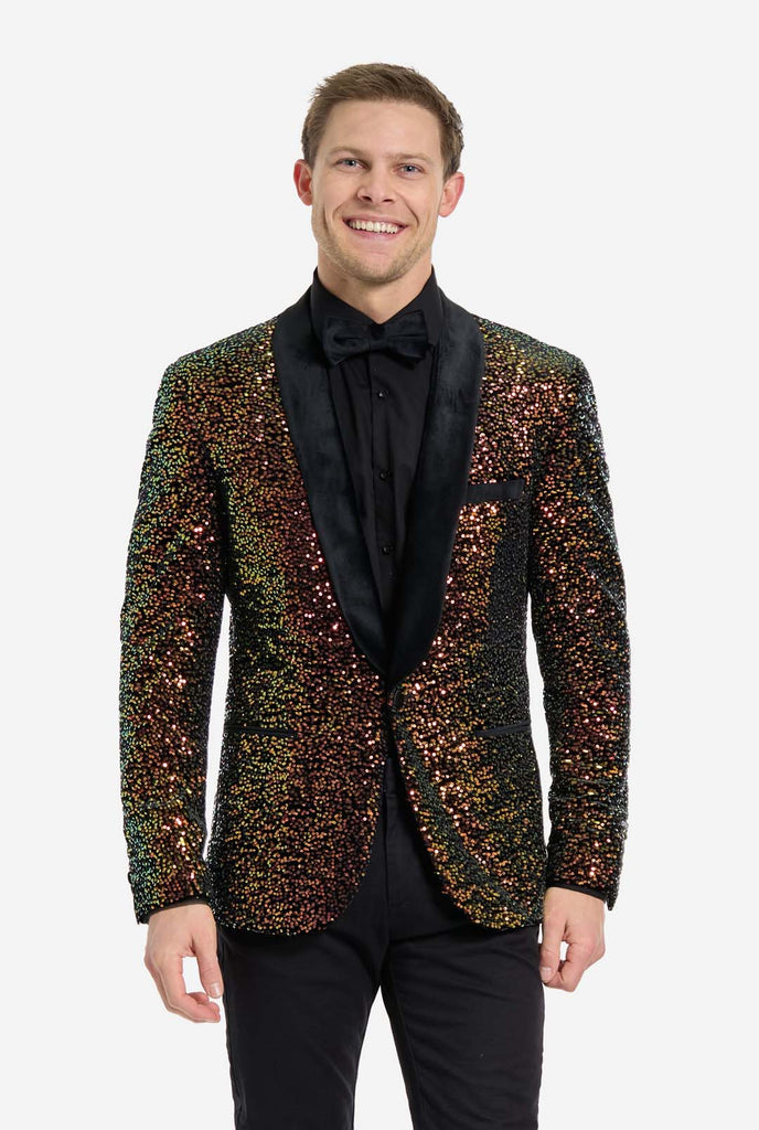 Man wearing blazer covered in with shimmering amber-colored sequins that reflect light in various shades of gold, copper, and green.