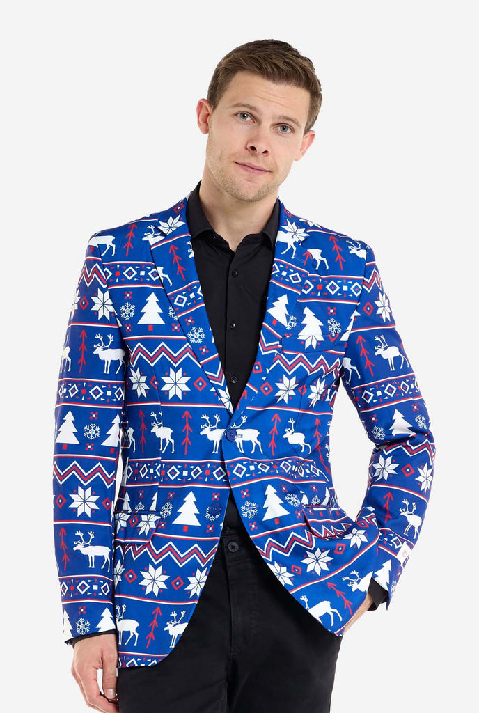 Man wearing blue Christmas blazer for men with Nordic Christmas figures. Man also wearing a black pants and black men's shirt.