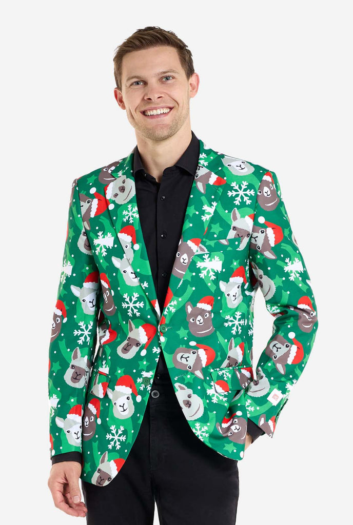 Man wearing green Christmas blazer for men with Christmas llamas. Man also wearing a black pants and black men's shirt.