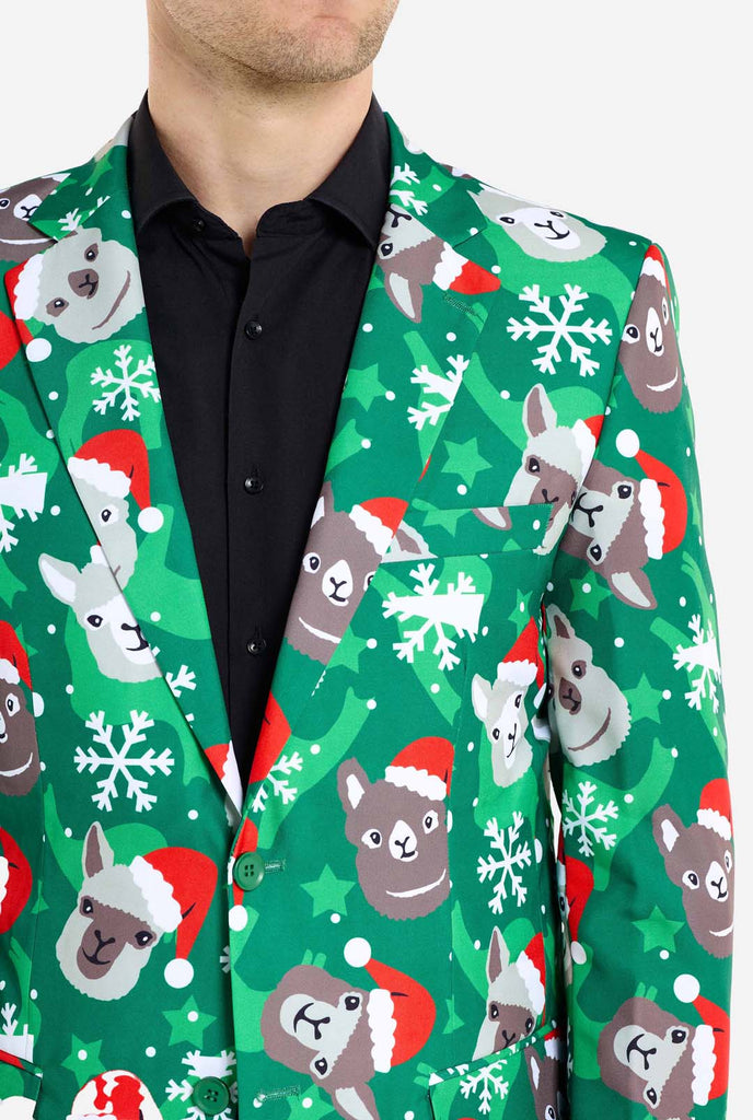 Man wearing green Christmas blazer for men with Christmas llamas. Man also wearing a black pants and black men's shirt. Chest close up.