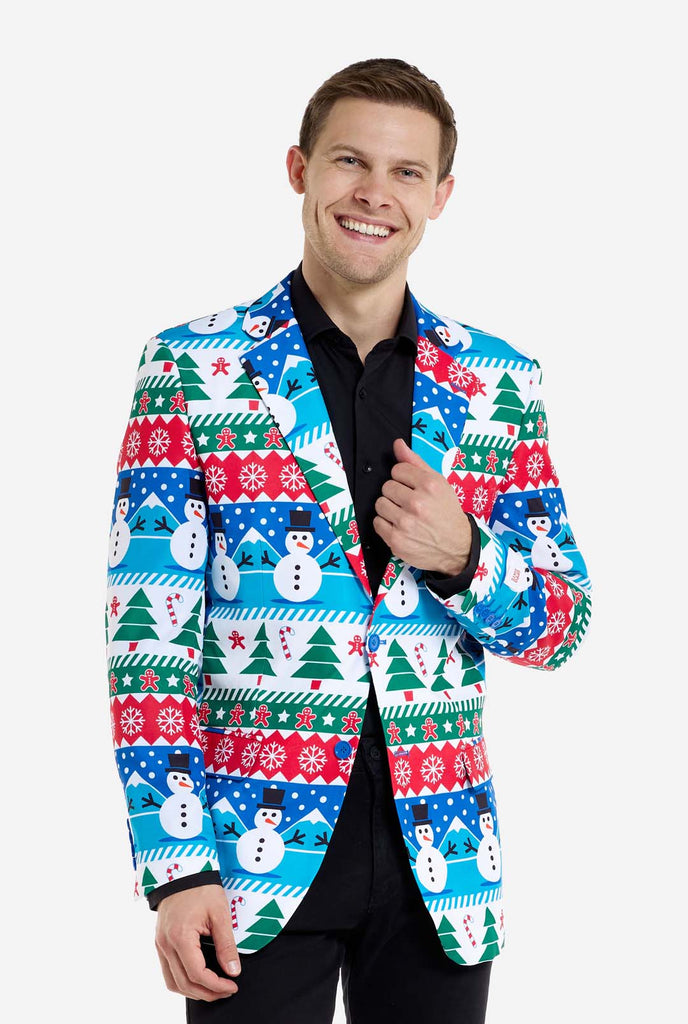 Man wearing Christmas blazer for men with Christmas winter figures. Man also wearing a black pants and black men's shirt.