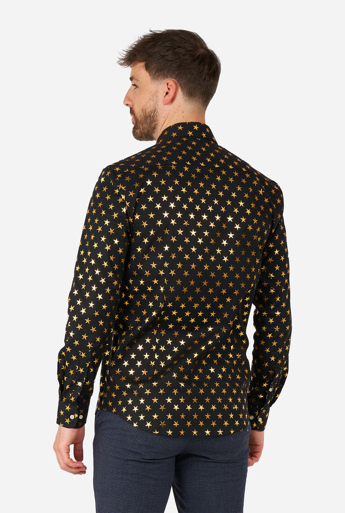 Man wearing black men's shirt with golden foil stars, view from the back