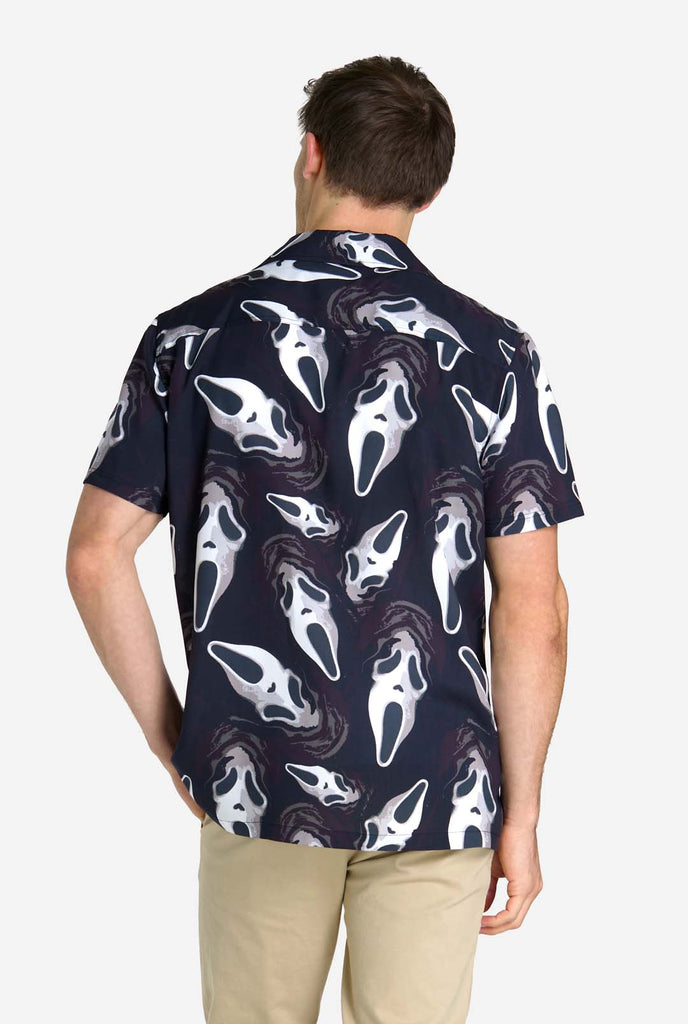 Man wearing black Hawaiian shirt with Ghostface print, view from the back