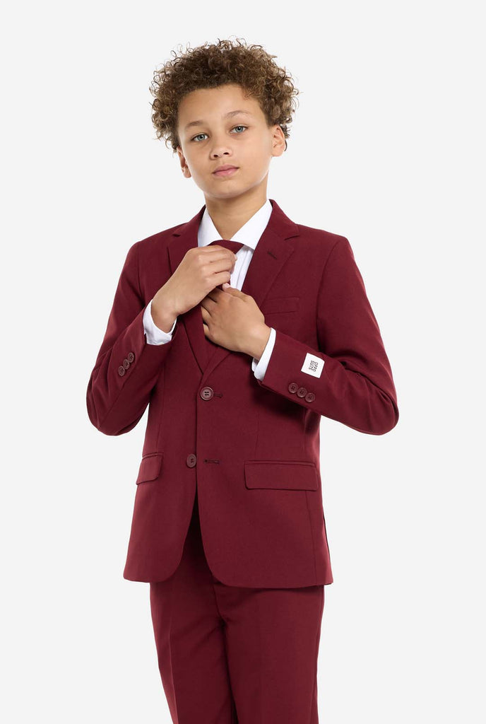 Teen wearing formal burgundy red suit