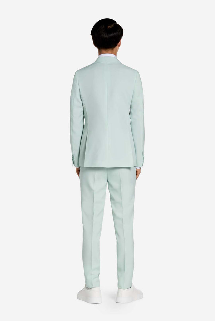Teen wearing mint green teen boys suit, view from the back