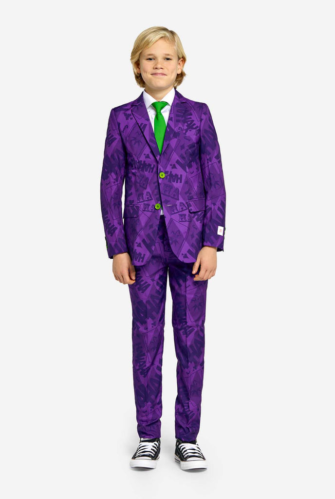 Teen wearing purple teen boys suit with a The Joker theme and green buttons. Further he is wearing a green tie and a white shirt. 