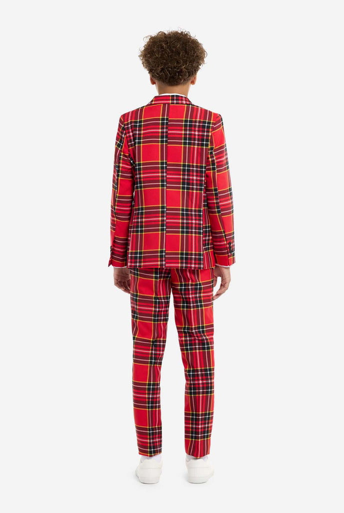 Teen wearing red tartan Christmas suit, view from the back