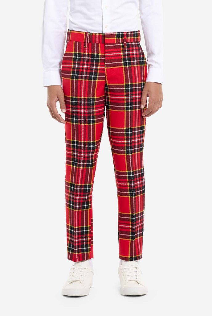 Teen wearing red tartan Christmas suit, pants view.