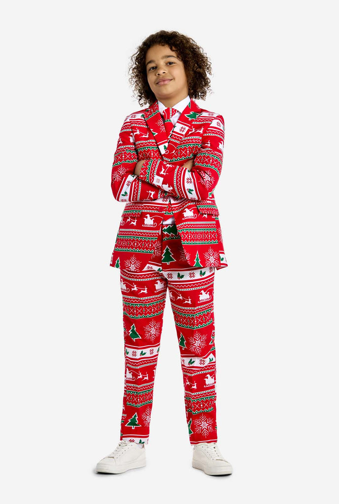 Teen wearing red Christmas suit with green and white Christmas icons, like Christmas tree, snowflakes, holly and sled with reindeers.