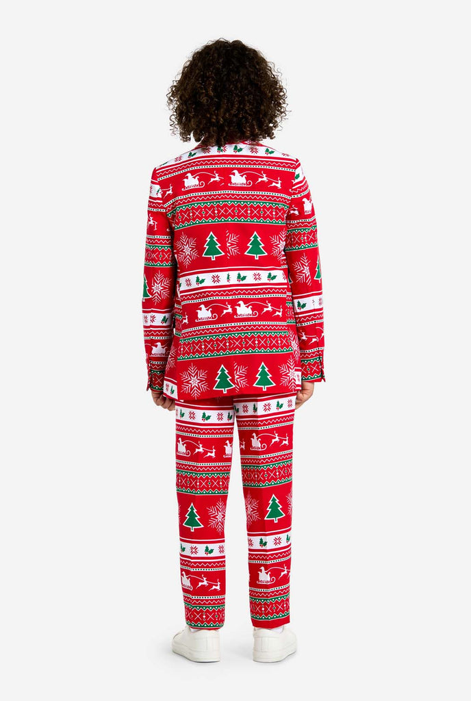 Teen wearing red Christmas suit with green and white Christmas icons, like Christmas tree, snowflakes, holly and sled with reindeers.