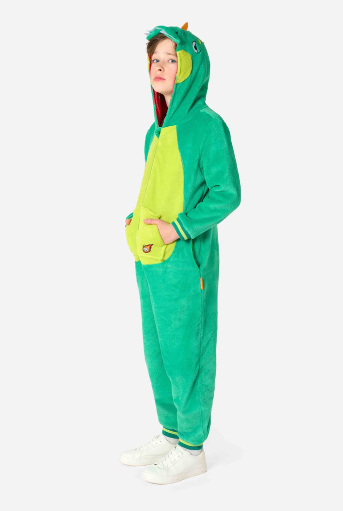 Kid is wearing green dino onesie for kids. Full body image.